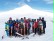 Das Foto zeigt ein Gruppenfoto, im Hintergrund ist ein schneebedeckter Berg zu sehen.